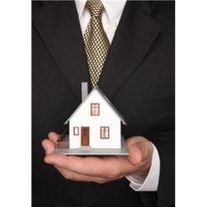 Man holding a model house in his hand