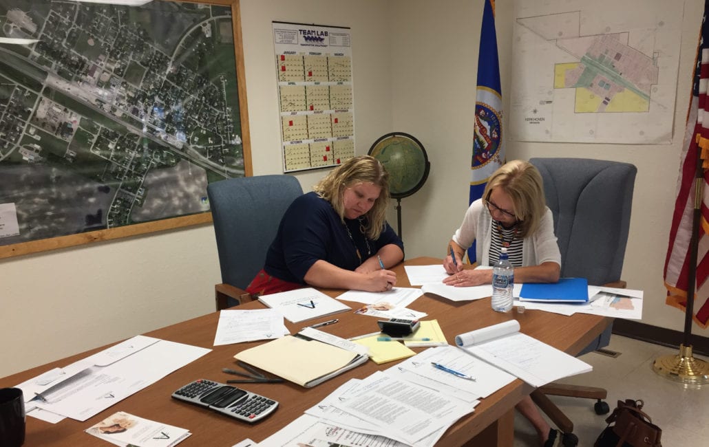 Linda Giersdorf and Kim Harkema signing grant award letter